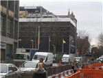 Top lift with roof extending over edge of building covered during refurbishment of a building in Molesworth Street Dublin.. Shrink film was used to create a dry environment for adding new brick facade. Gallery Thumbnail